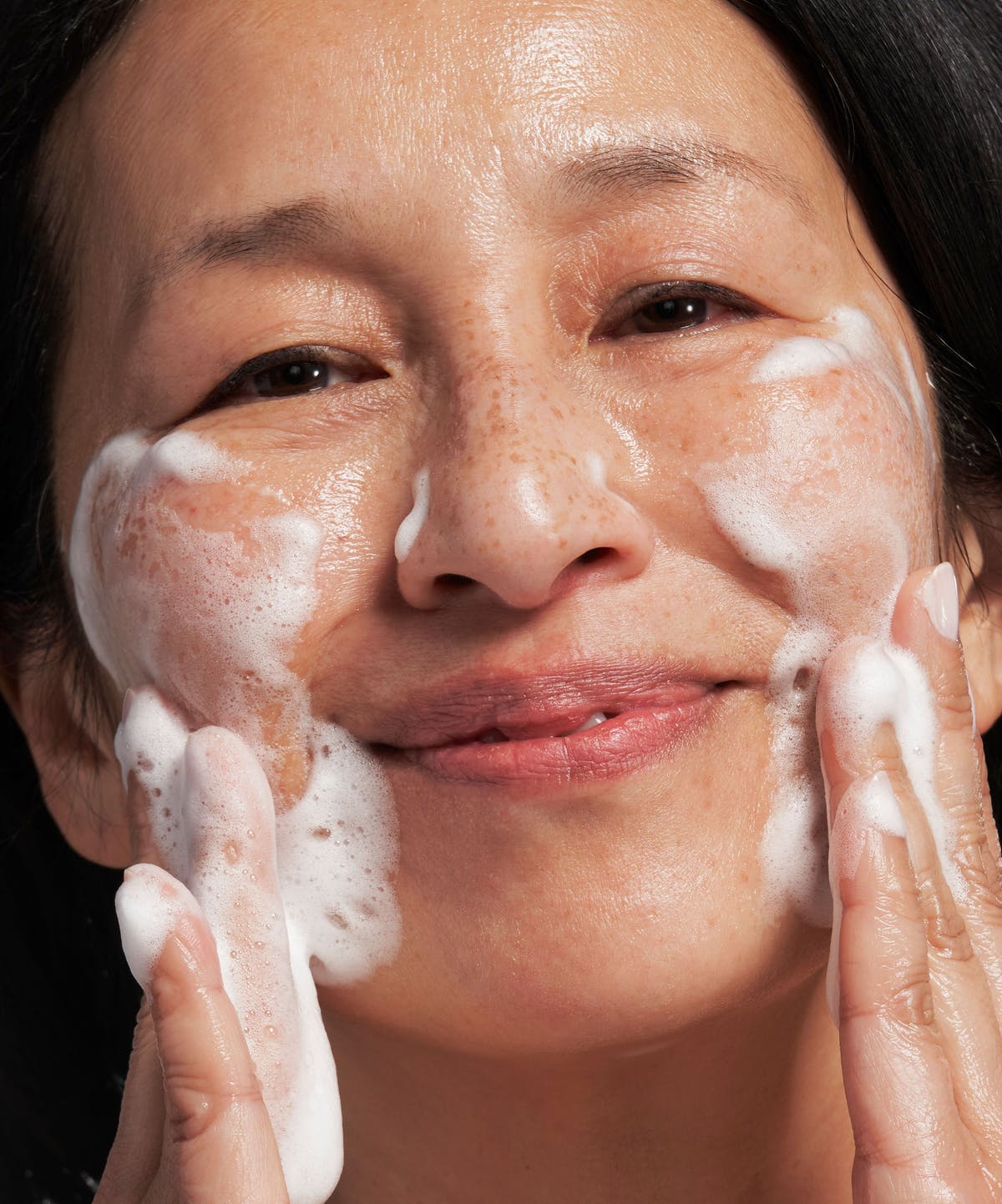 Real person's skincare routine in natural daylight bathroom setting